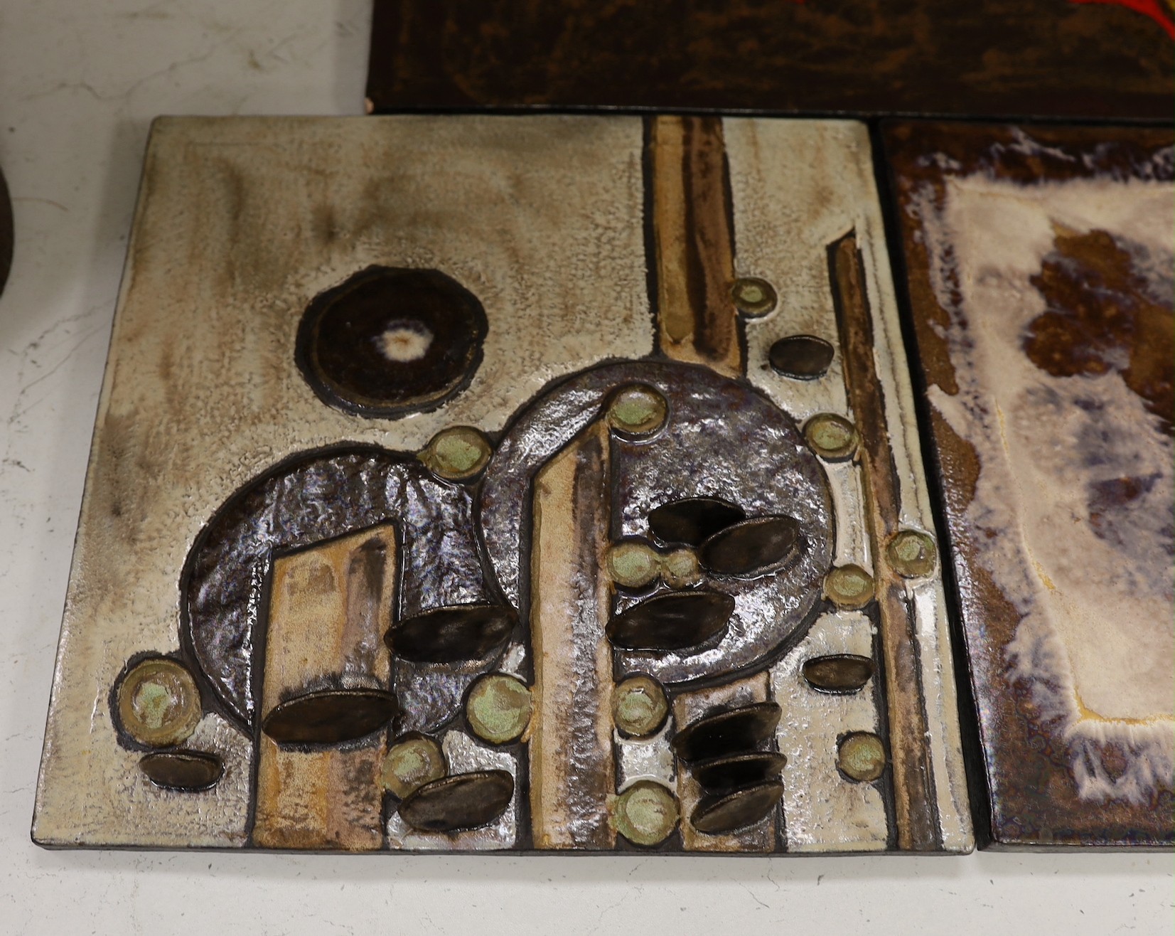 Two West German Ruscha pottery wall plaques and two studio pottery metallic glazed plaques. Largest 35x60cm